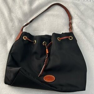 Pre-owned nylon Dooney & Burke black purse. It has a pretty red interior.